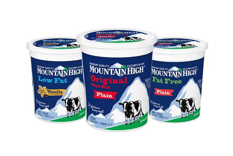 3 tubs of mountain yoghurt, all different types, in a triangle formation. One is a plain whole milk, another plain fat free, and the last vanilla low fat.