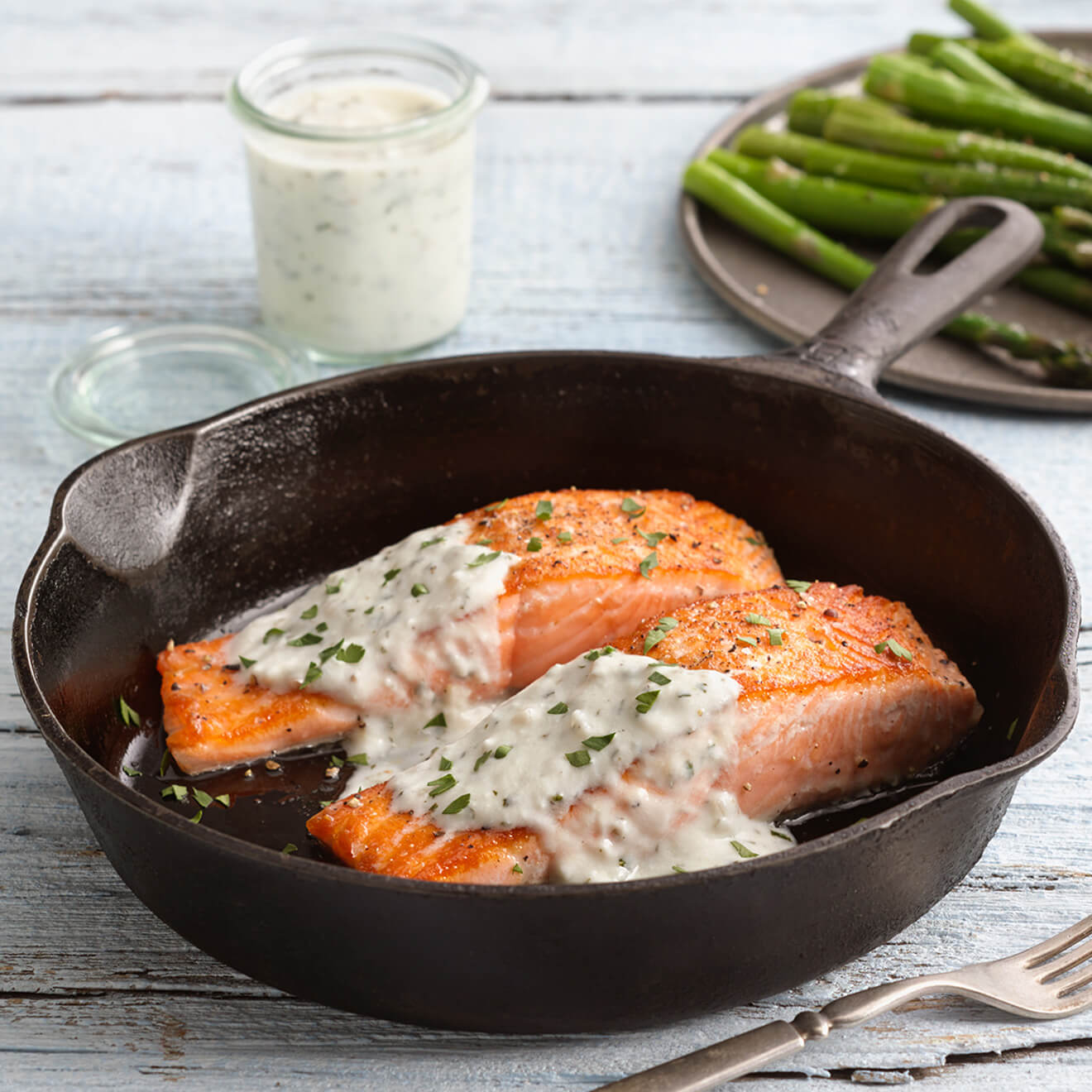 two salmon filets in a cast iron skillet