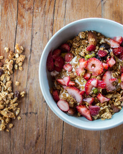 bowl of yoghurt with granola and strawberries