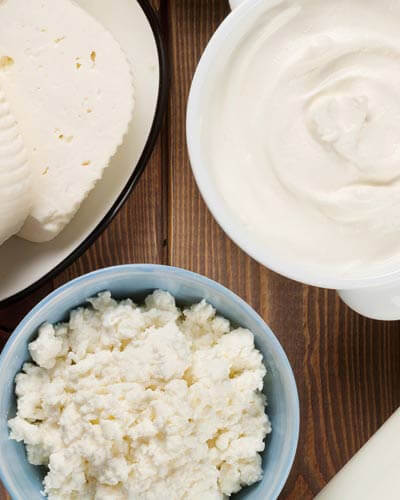 Yogurt, cheese, milk. and other dairy products arranged in bowls